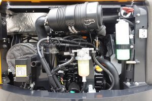 Yuchai Americas excavator engine compartment showing detailed view of engine components, air filter, and cooling system