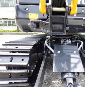 Yuchai Americas excavator undercarriage close-up, showing track links, pivot joint, and hydraulic components, demonstrating robust construction