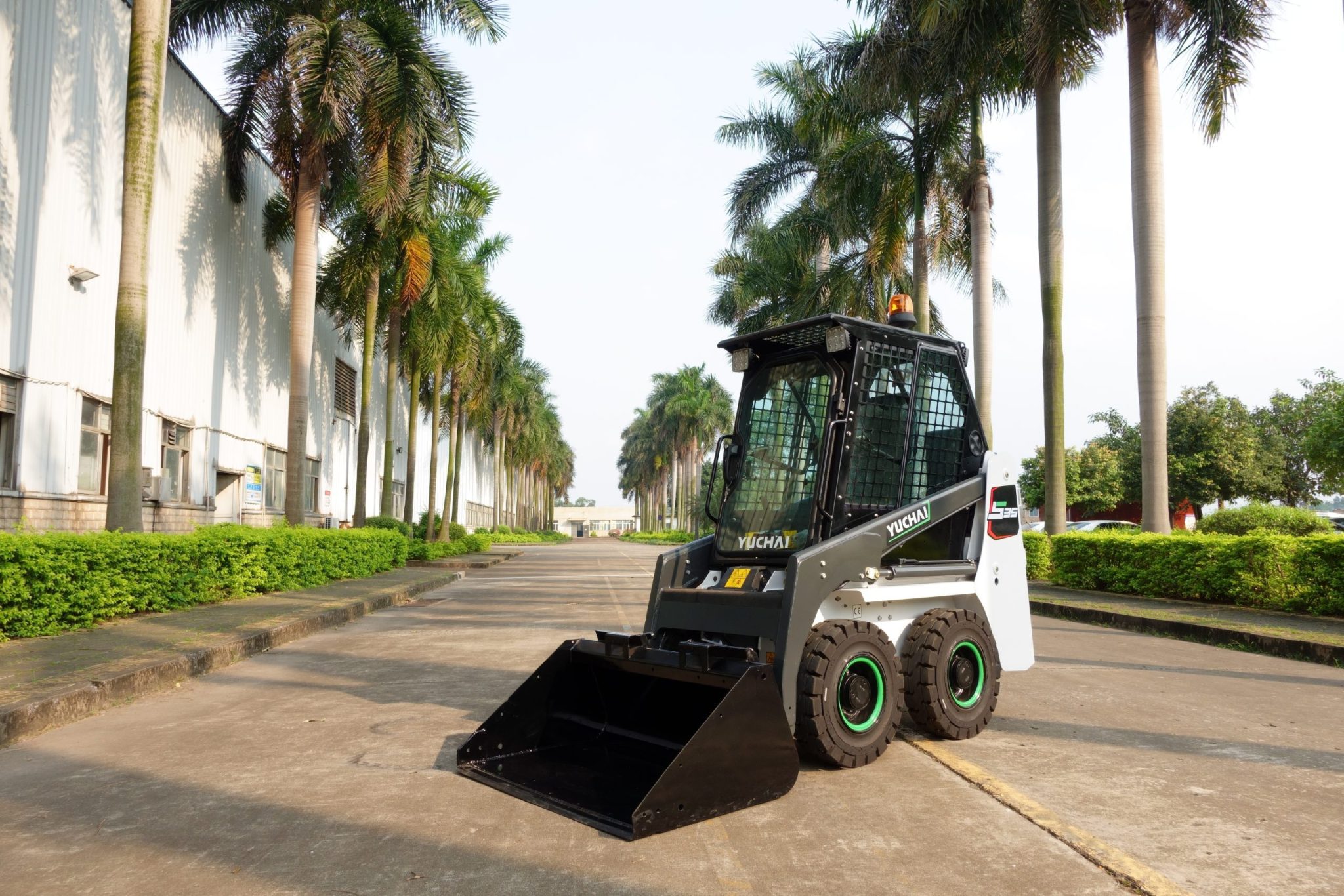 Yuchai Americas Skid Steer Loader in Tropical Industrial Setting