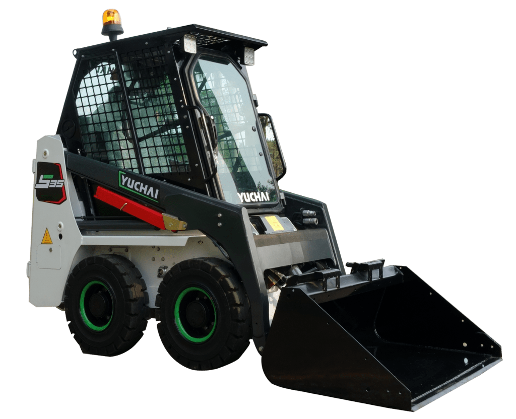 Yuchai Americas S35 skid steer loader with enclosed cab, black front bucket, and four large tires with green-accented rims